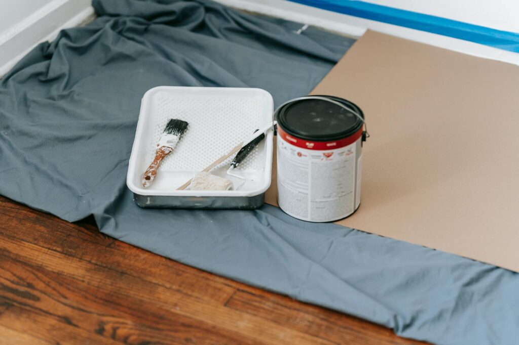 Dresser being painted with chalk paint and a natural bristle brush